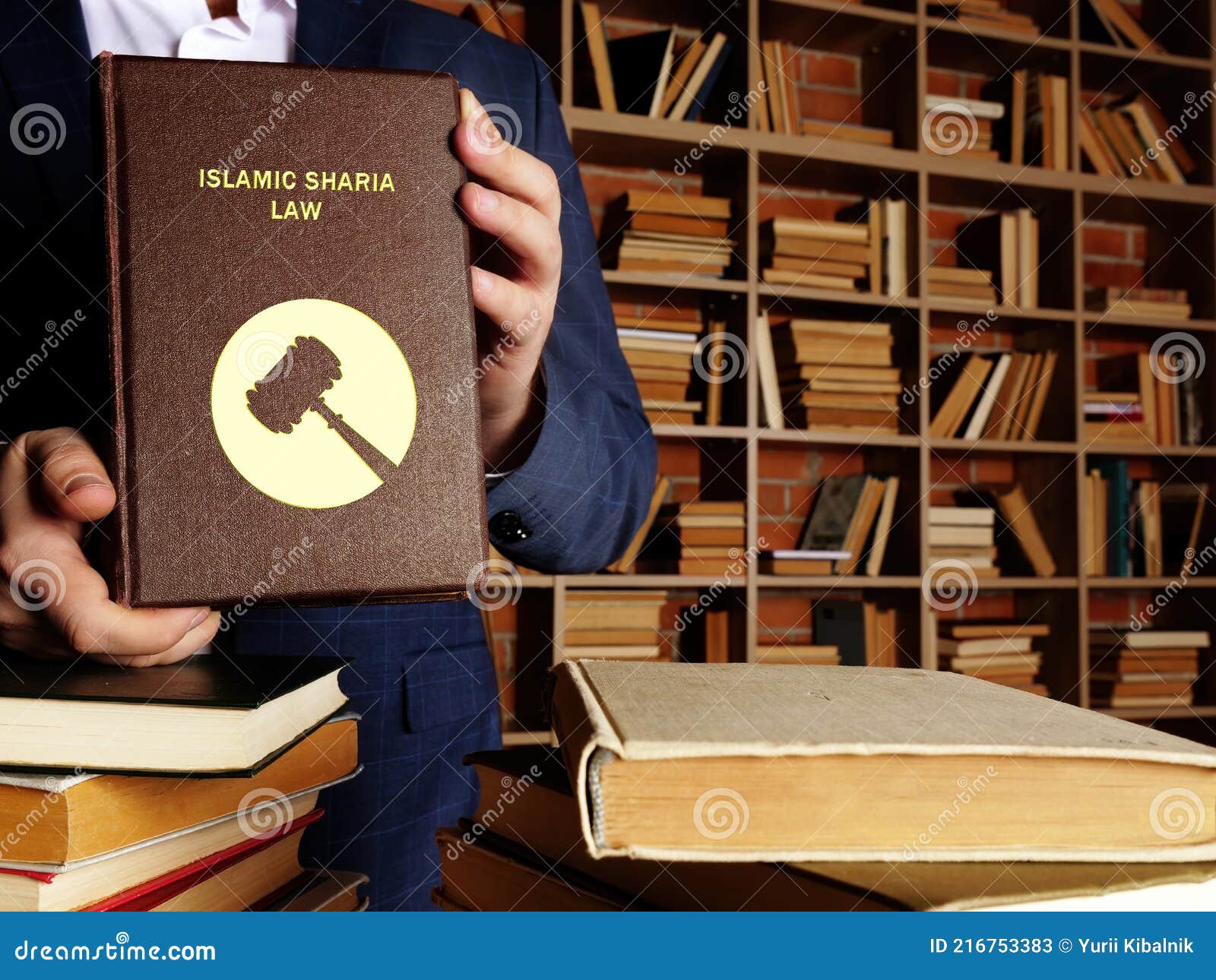 islamic sharia law book in the hands of a jurist. sharia lawÃÂ isÃÂ islam`sÃÂ legal system. it is derived from bothÃÂ theÃÂ koran